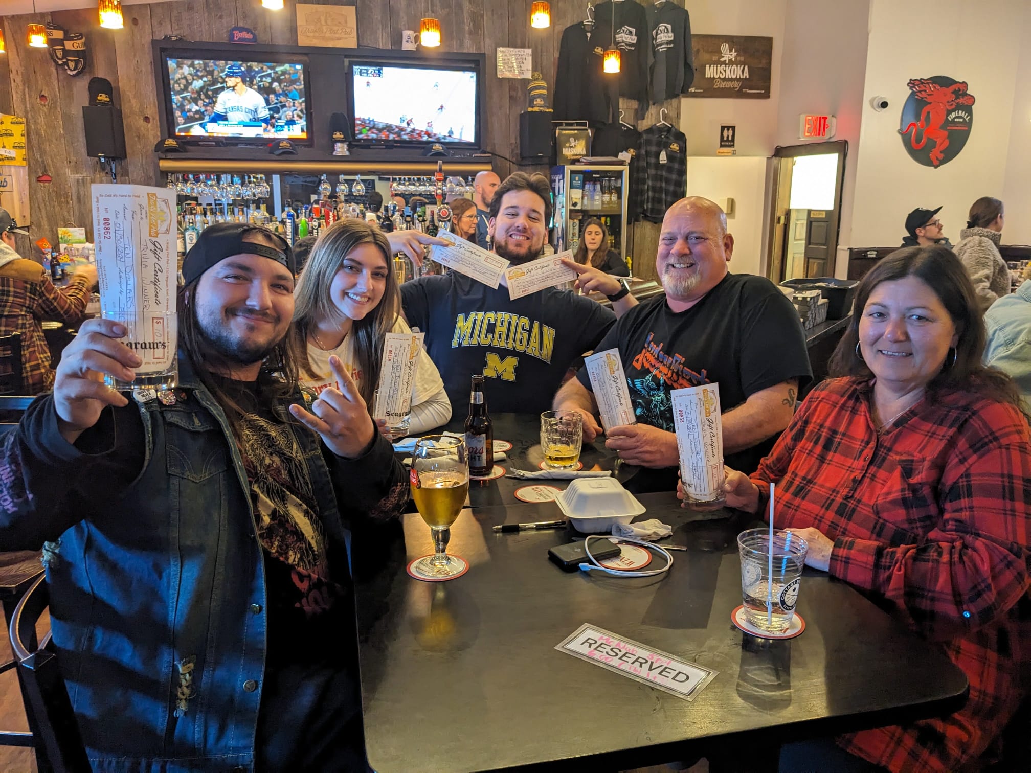 Trivia winners holding gift certificates at The Frosty Pint